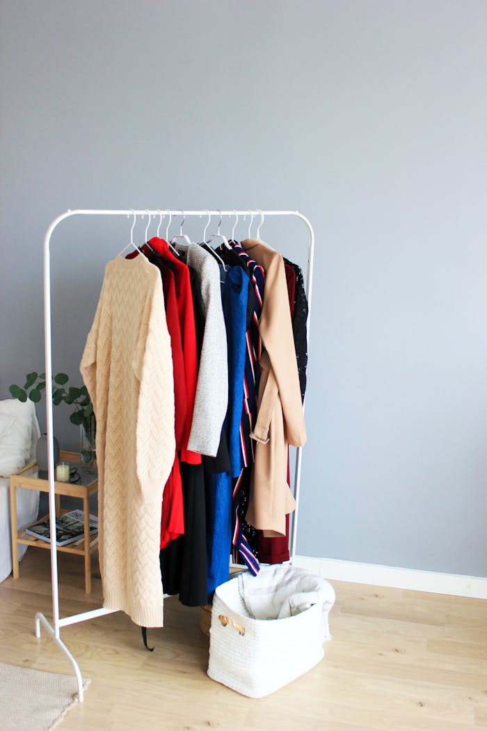 Elegant selection of clothes on a minimalist rack in a modern interior setting.